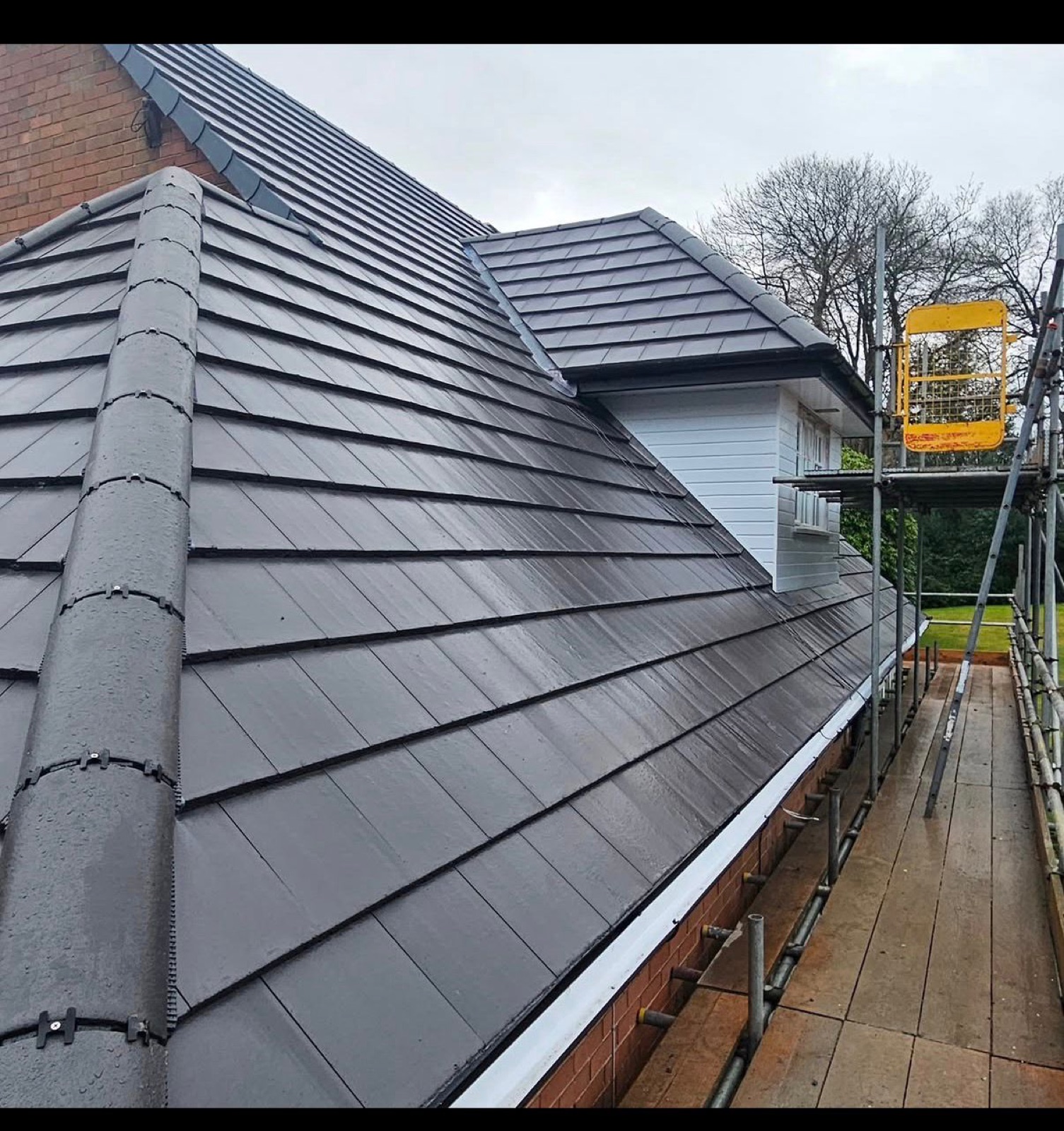 Interlocking tile re-roof with scaffolding